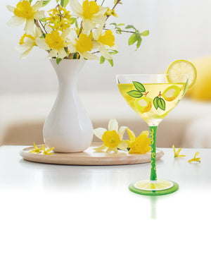 LOLITA Lemon Drop Cocktail Glass beside a vase of daffodils